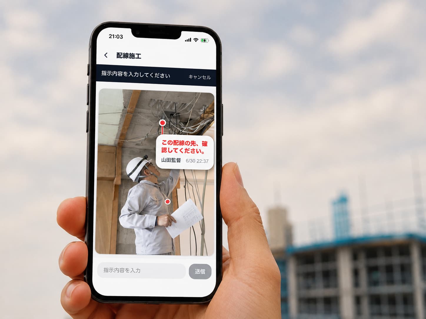 スマートフォンでGemba Captureの赤ペンコメント機能を確認する建設現場の作業員